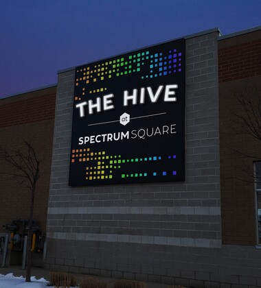 The hive sign on a building at night
