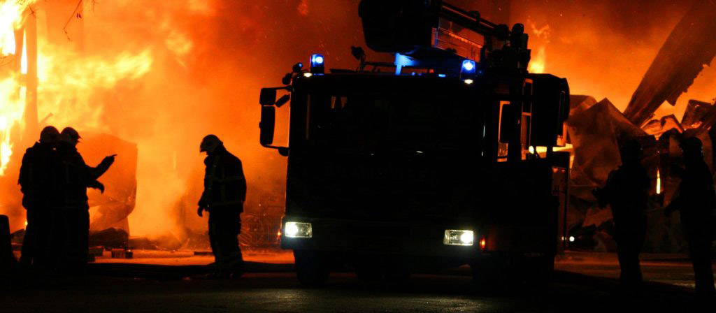 Fire fighters with fire in the background